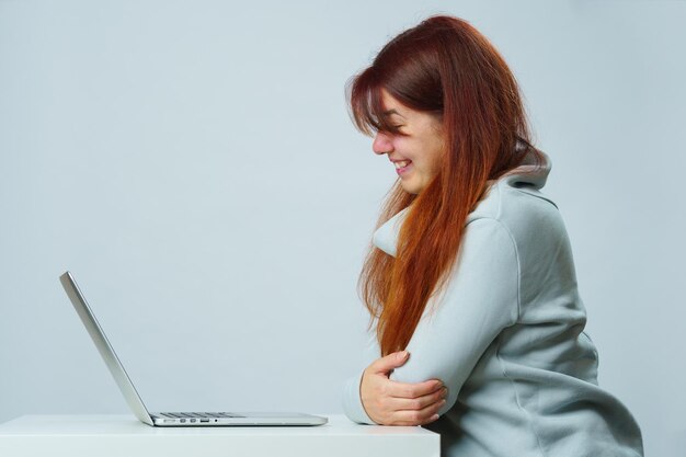 Woman is sitting at table and using laptop for communication in chat or video chat Social media concept