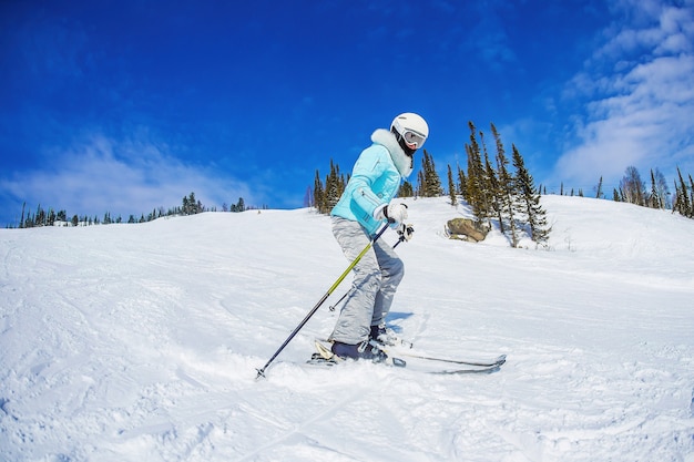 Woman is skiing in the mountains Sheregesh.