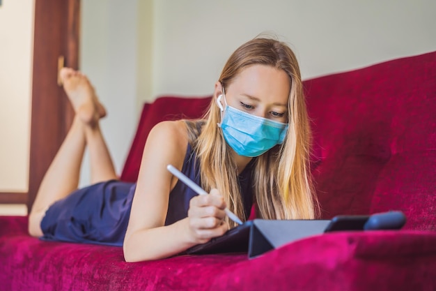 Woman is teaching drawing on a tablet at home in quarantine Coronovirus selfisolation