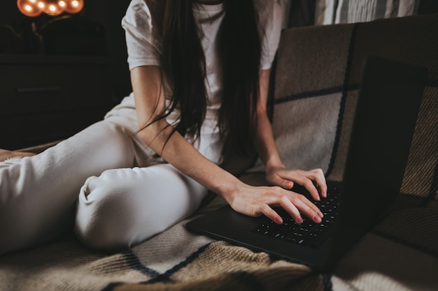 Woman is typing on a laptop keyboard