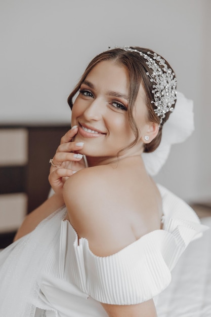 A woman is wearing a white dress and a headband