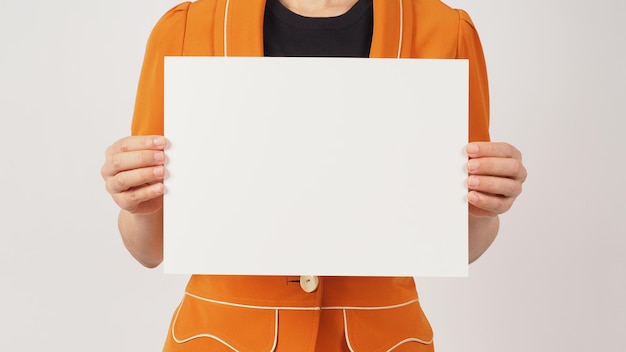 Woman is wearing a yellow mustard suit and holding the blank paper board horizon line on white background Body part