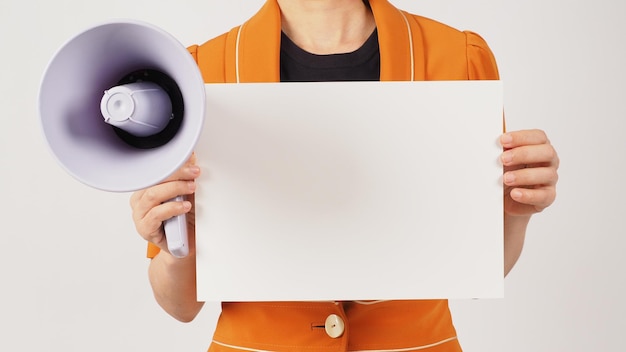 Woman is wearing a yellow mustard suit and holding the blank paper board on white background Body part