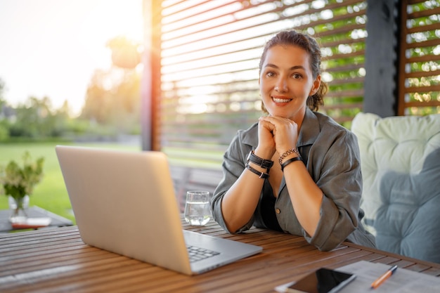 Woman is working sitting on the patio