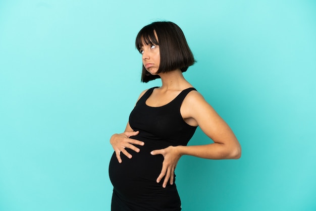 Woman over isolated background pregnant