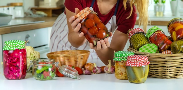 Woman jar preserve vegetables in the kitchen Selective focus