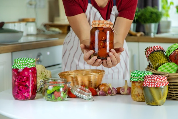 Woman jar preserve vegetables in the kitchen Selective focus