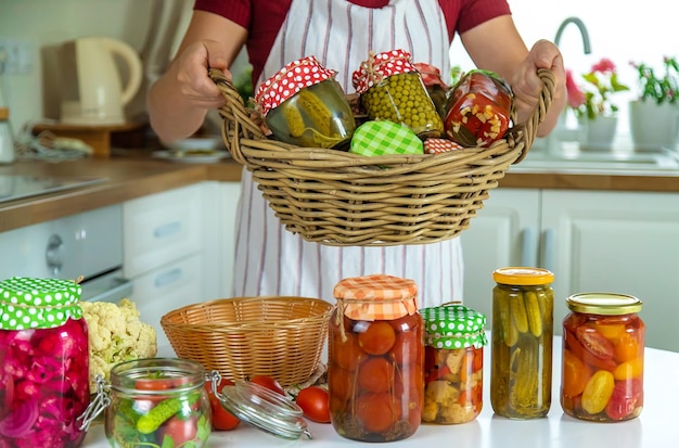 Woman jar preserve vegetables in the kitchen Selective focus