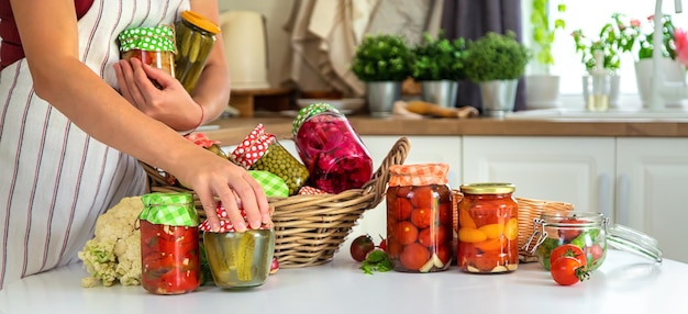 Woman jar preserve vegetables in the kitchen Selective focus