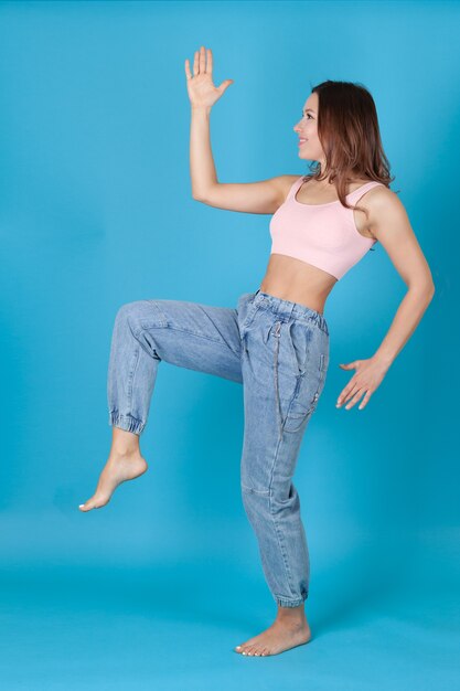 woman in jeans dances like a puppet