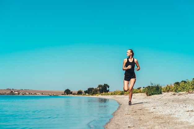 The woman jogging along the sea coast