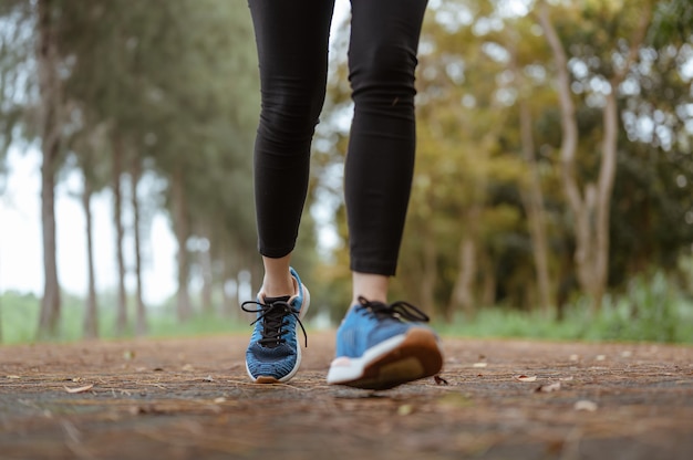 A woman Jogging in the natural park. Legs close up.