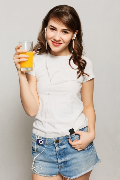 Woman juice glass . Female model hold orange juice glass