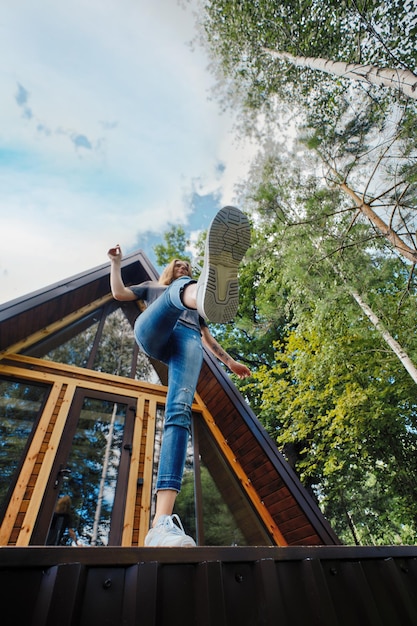 Woman jumps off the porch of log cabin