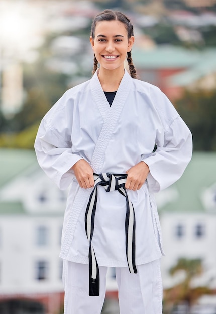 Woman karate and smile in outdoor portrait with happiness for training fitness and wellness in sunshine Girl martial arts and self defence with happy sport and motivation in metro town or city