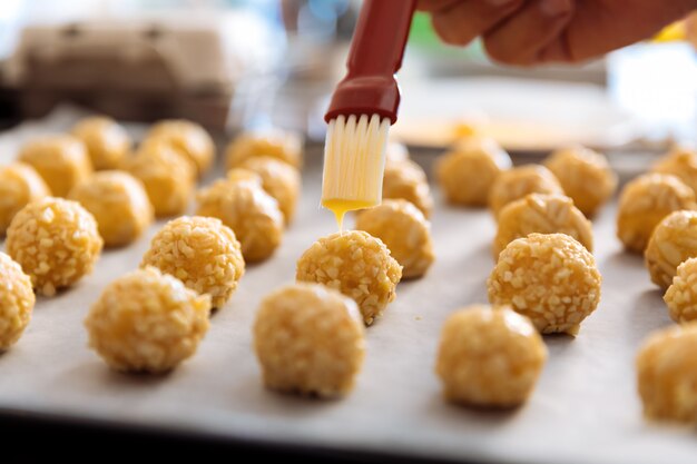 Woman kneading marzipan for make panellets.