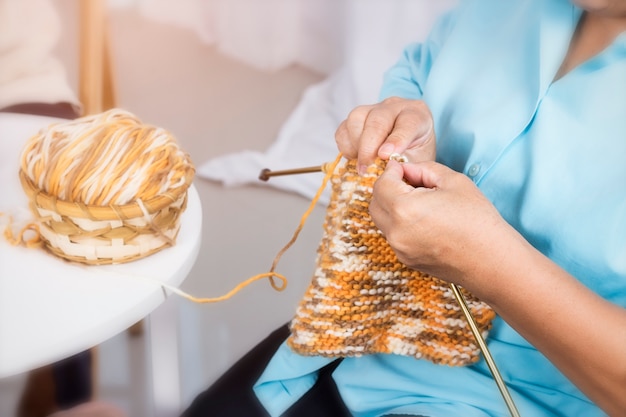 Woman knitting wool