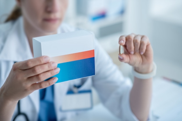 Woman in a lab coat presenting new medicine