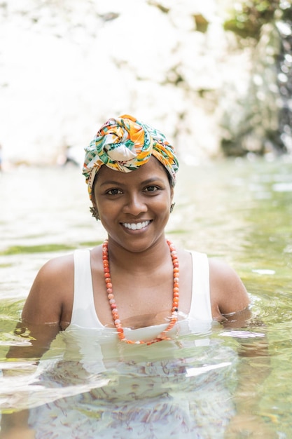 Woman laughing and having fun while swimming in the river