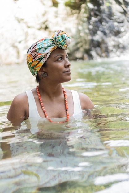 Woman laughing and having fun while swimming in the river