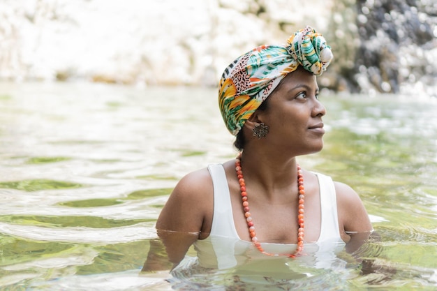 Woman laughing and having fun while swimming in the river