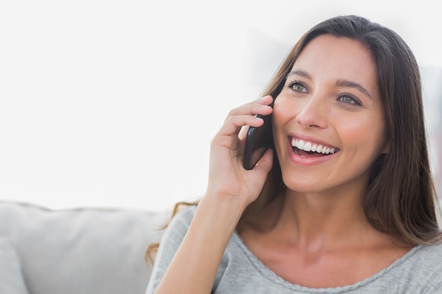 Woman laughing while she is on the phone