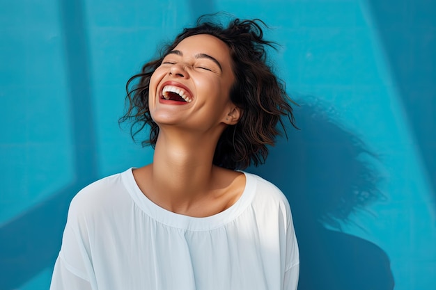 a woman laughing with her eyes closed