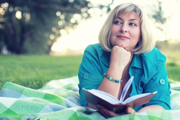 Woman lay and read book sun