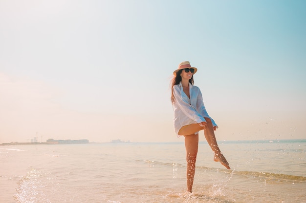 Woman laying on the beach enjoying summer holidays looking at the sea