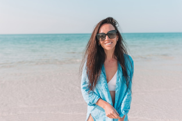 Woman laying on the beach enjoying summer holidays