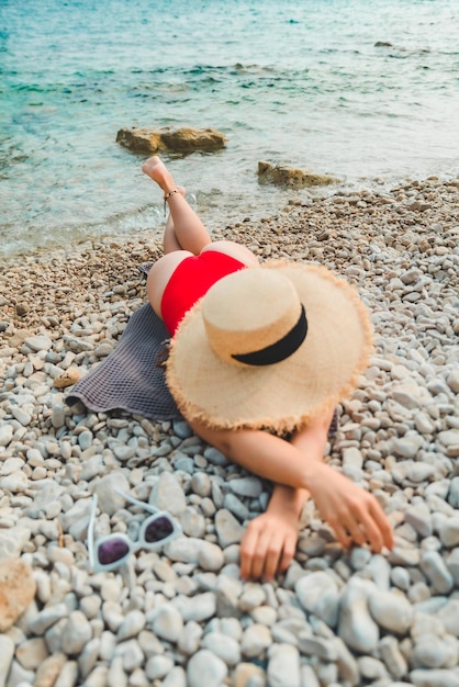 Woman laying on blanket at sea beach