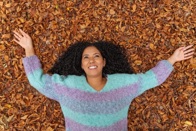 A woman laying on the ground with her arms outstretched