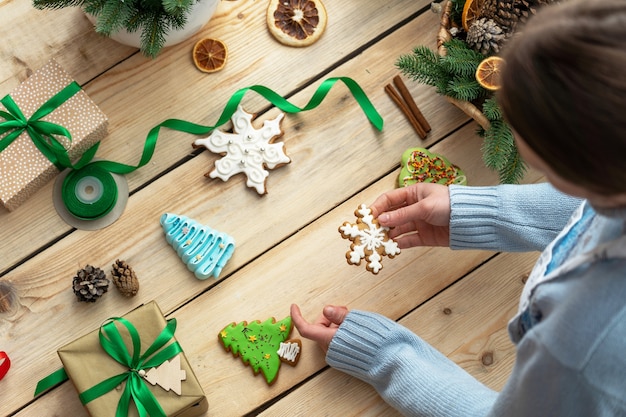 woman lays out iced gingerbread on a  table