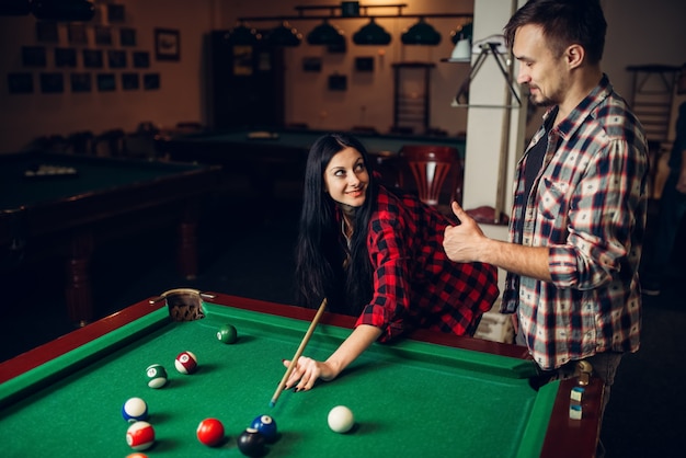 Woman learn to play billiard