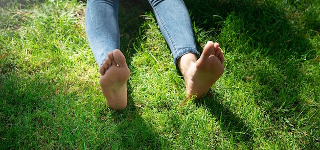 Woman legs relax feeling on green grass background