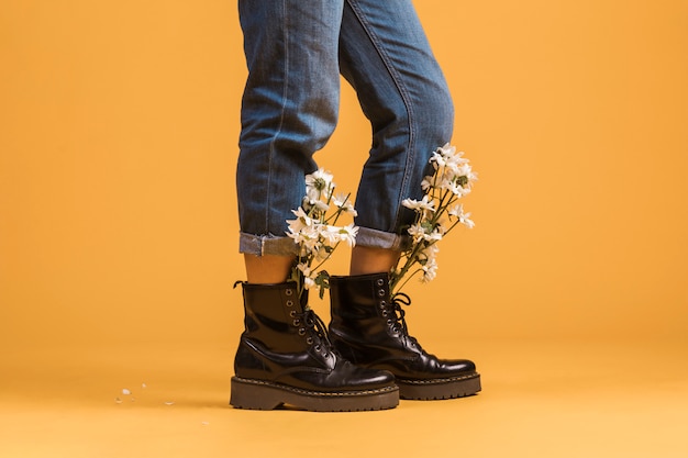 Woman legs wearing in boots with flowers inside