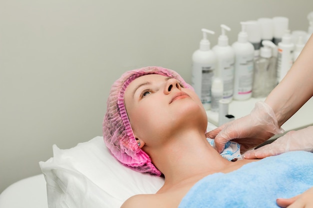 A woman lies down and prepares to undergo a cosmetic or clinical procedure