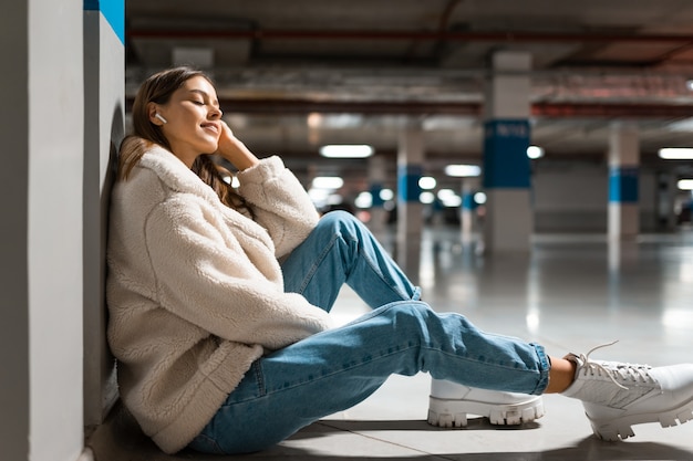 Woman listen to music in wireless headphones