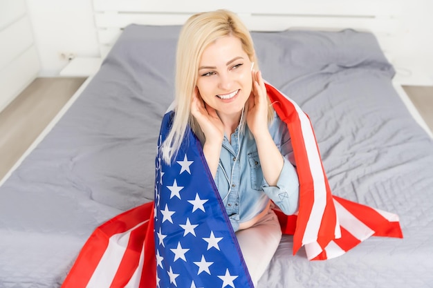 Woman Listening English Language Learning Course Audiobook In Front Of American Flag.