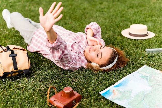 Woman listening to music on headphone on the ground