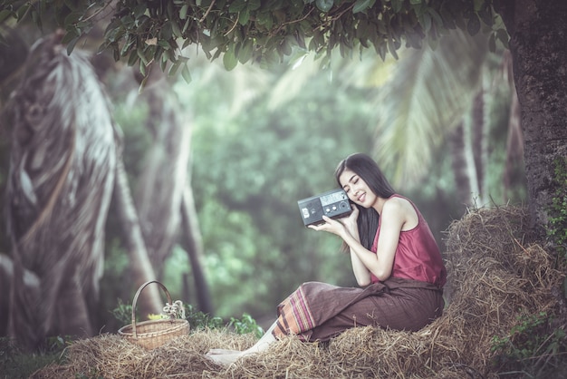 Woman listening to radio in countryside