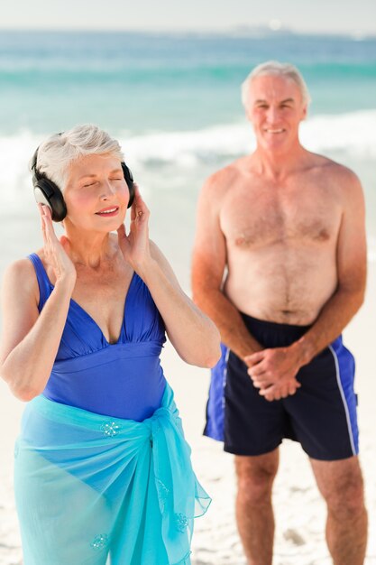 Woman listening to some music at the beach