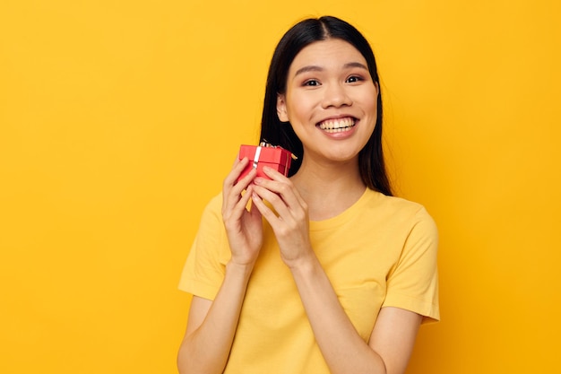 Woman little red gift box fun yellow background unaltered