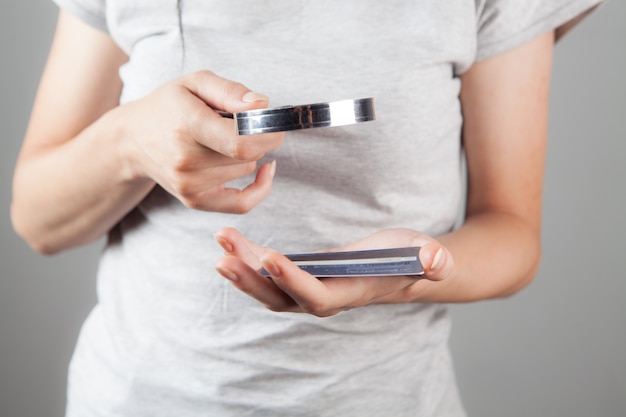 Woman looking at a bank card with a magnifying glass