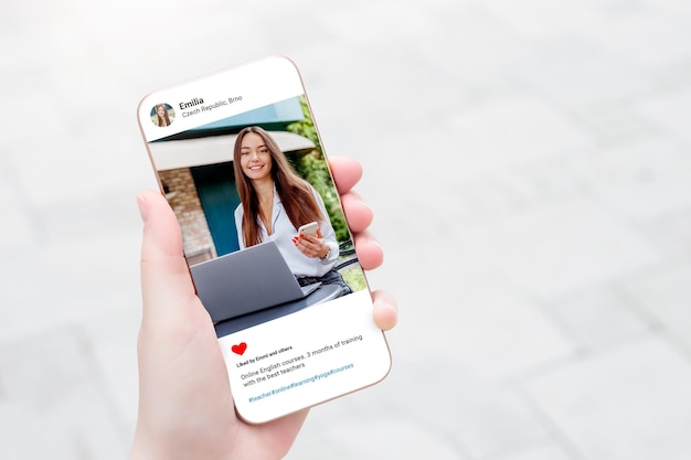 Woman looking at beautiful businesswoman photo on mobile phone