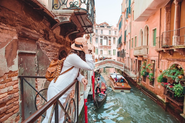 Woman looking at canal with gandola