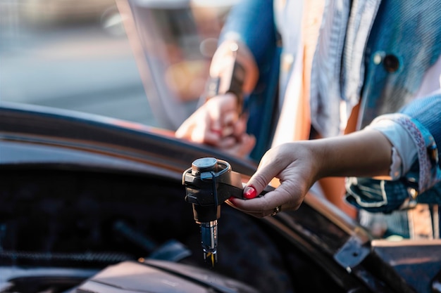 Woman looking at her car to solve a problem