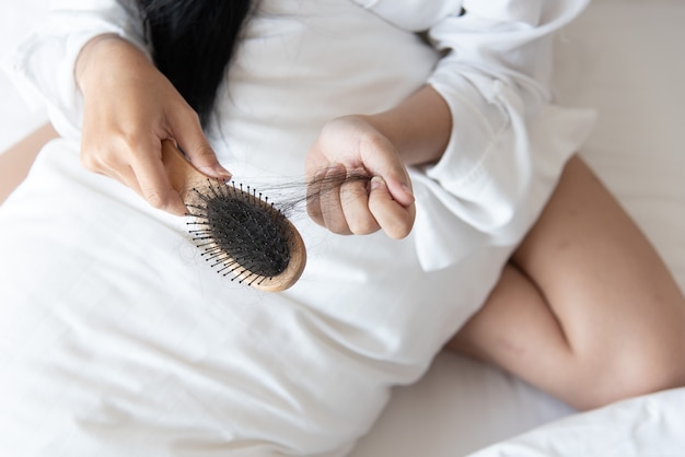 woman looking at her hair for hair loss problem