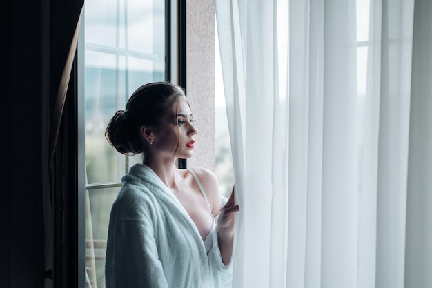 Woman looking out of the window morning woman