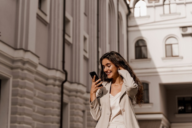 Woman looking at smartphone and smiles